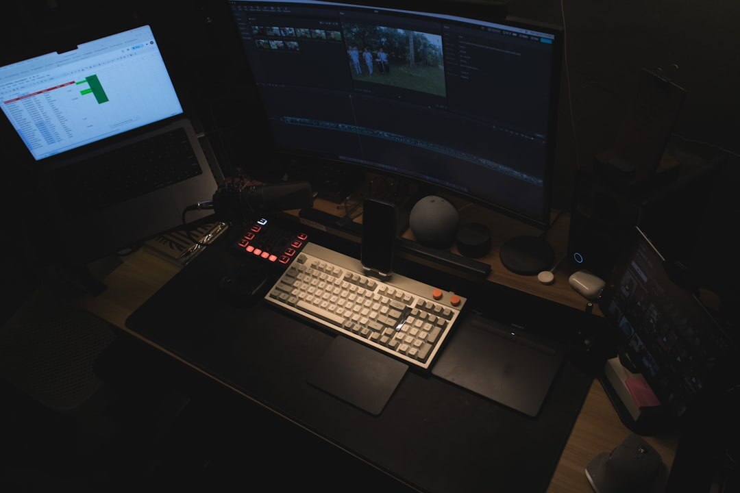 Video editor working at a multi monitor editing desk with timeline software