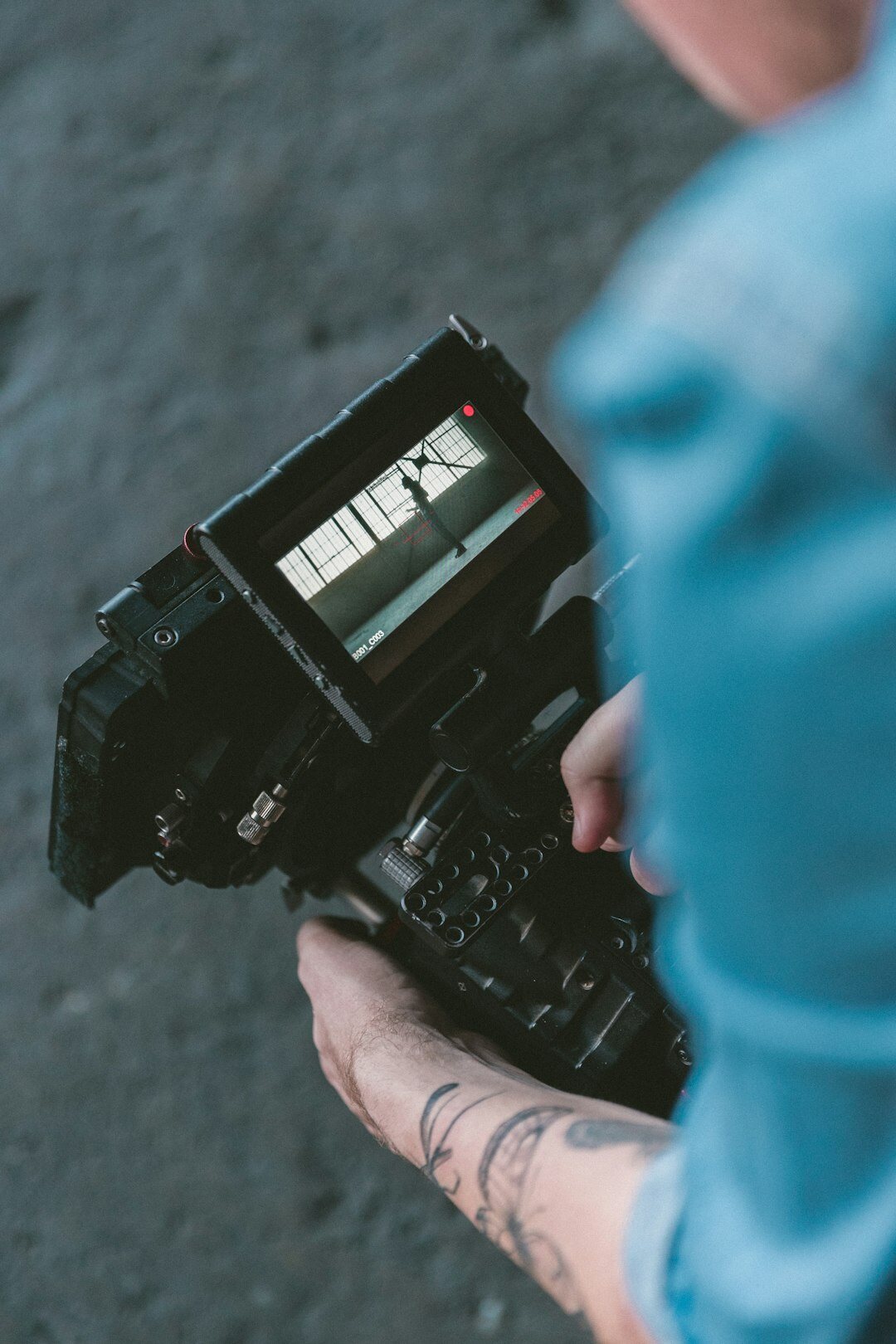 Finnish camera operator holding a professional broadcast camera in a TV studio
