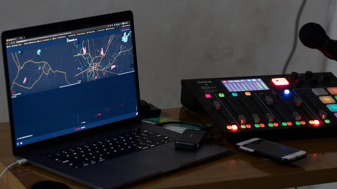 Laptop displaying a live broadcast dashboard interface on a desk