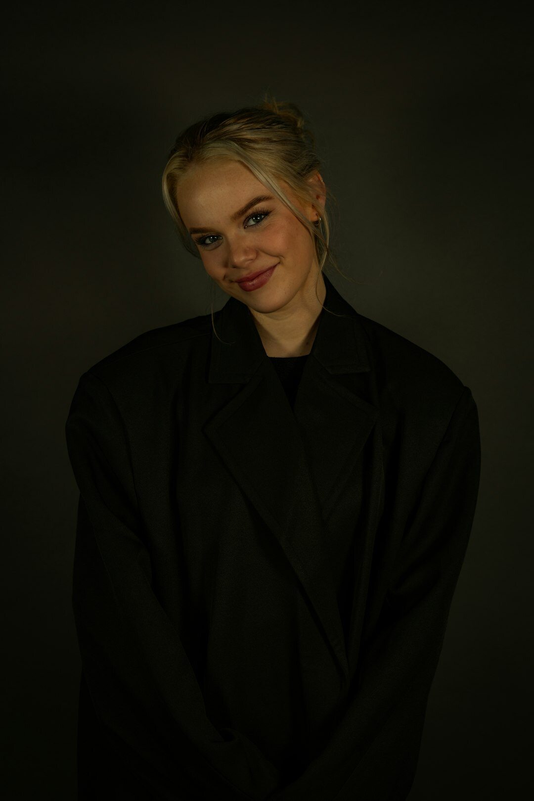 Studio portrait of a Finnish woman in her 30s wearing a blazer
