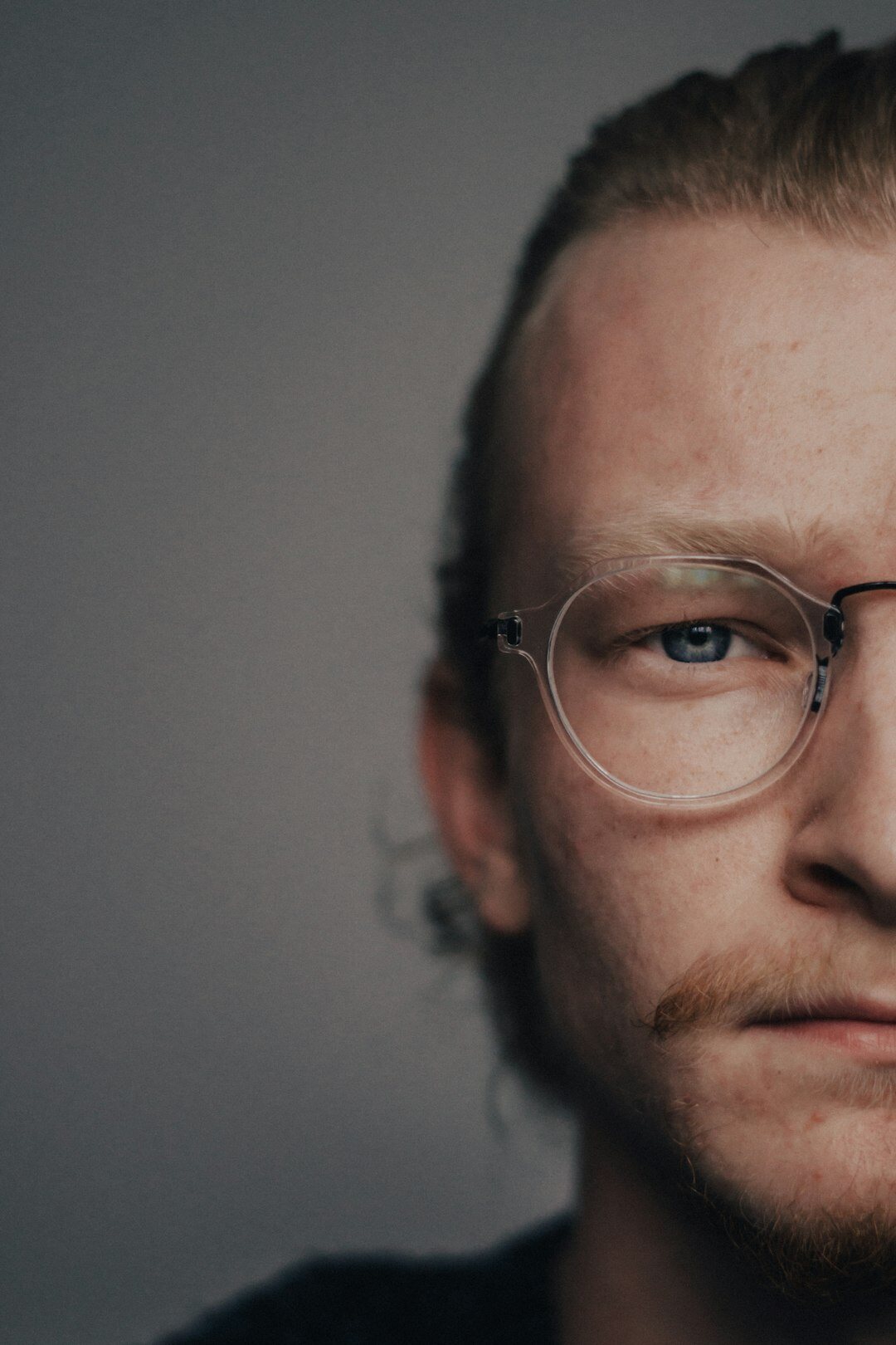 Studio portrait of a Finnish man in his 30s with glasses
