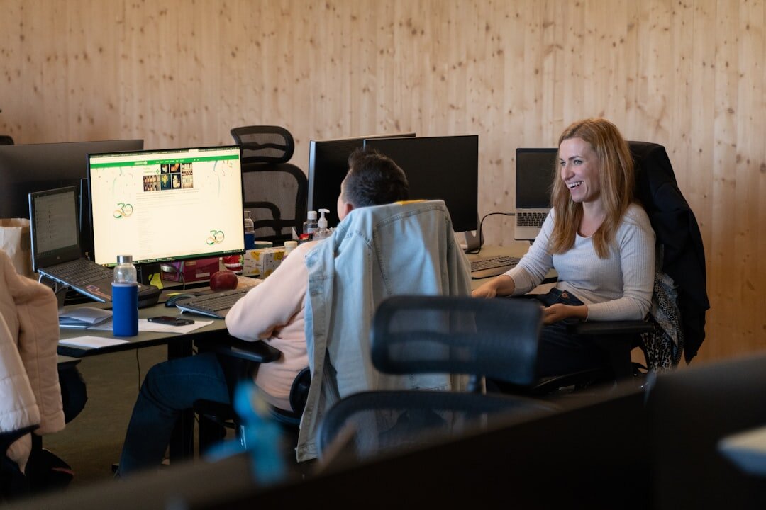 Finnish media production team collaborating around monitors in an office